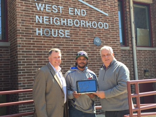 Durrell Downing (center), Precision AirConvey star employee, stands with Tom Embley, CEO, President (left) and Paul Calistro, Jr., Executive Director (right) at West End Neighborhood House. Precision AirConvey donated six laptops for career and educational purposes to honor of Downing, a graduate of the West End Neighborhood House program.